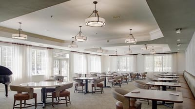 Bright dining room with round tables and large windows
