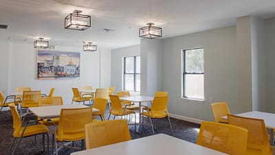 Bright interior common area with yellow chairs