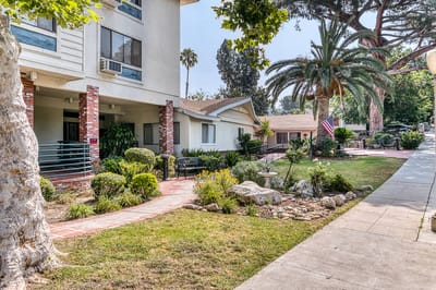 Exterior view of an assisted living facility with gardens