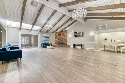 Interior view of a common area with seating and a piano