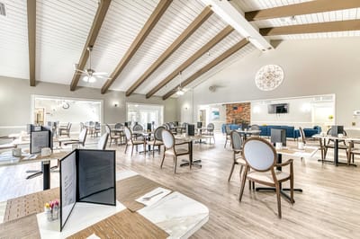 Bright and spacious dining area with tables and chairs