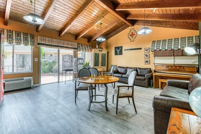 Bright common area with seating and piano
