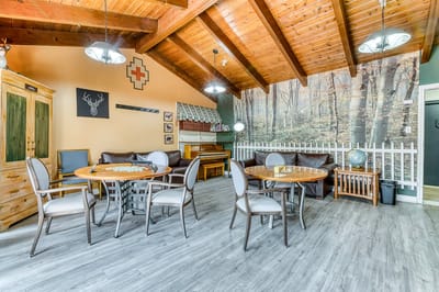 Common area with tables and chairs in a cozy interior