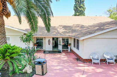 Entrance of Leisure Vale Assisted Living with palm trees