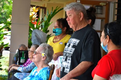 Residents and staff celebrating together outdoors