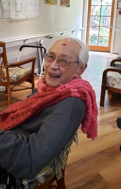Elderly resident smiling in common area