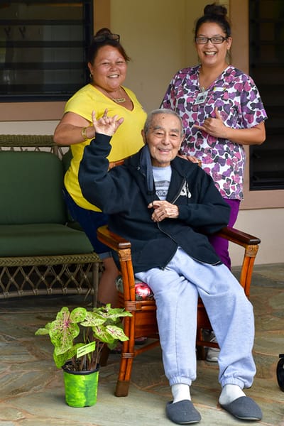 Residents and staff posing happily outdoors
