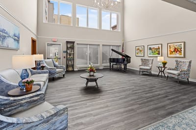 Bright common area with seating and piano