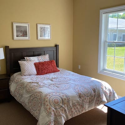 Cozy resident bedroom with a bed and natural light