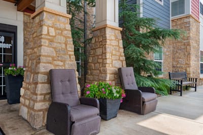 Outdoor seating area with potted flowers
