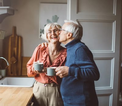 Couple enjoying coffee together in a cozy kitchen