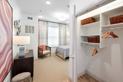 A well-furnished private resident room with a bed and decor