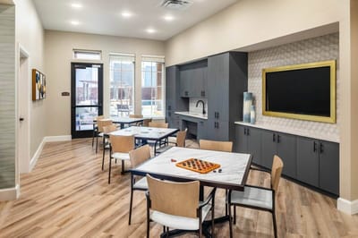 Common area with tables and seating in a bright interior