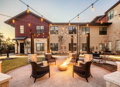 Outdoor seating area with string lights and a fire pit