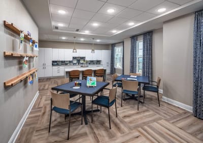 Interior view of an activity room with tables and chairs