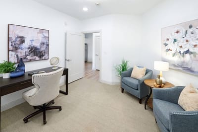 Comfortable interior room with seating and desk