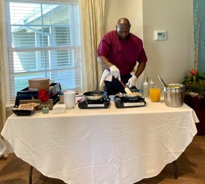 Chef preparing a meal in a dining area