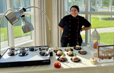 Chef presenting gourmet desserts in a common area