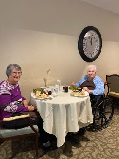 Two residents enjoying a meal in the dining area