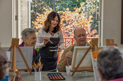 Residents painting during an art activity with staff