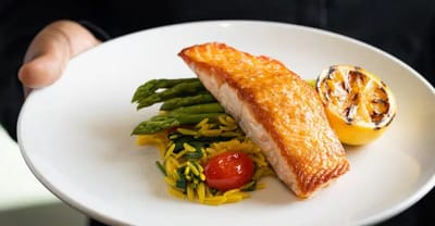 A plated meal featuring salmon and asparagus