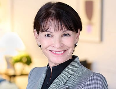 A smiling woman in professional attire