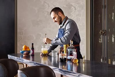 A person making a drink at a modern counter