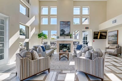 Bright common area with seating and large windows
