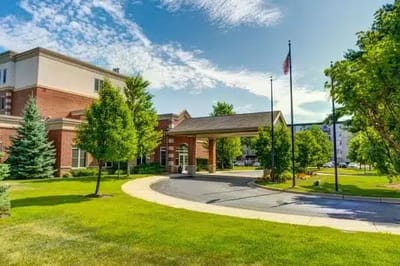 Exterior view of Montclair Senior Living with landscaped entrance
