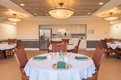 Bright dining room with tables set for a meal