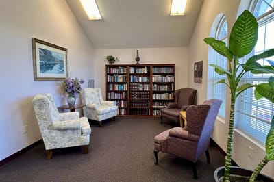 Cozy reading nook with bookshelves and chairs