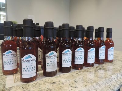 Bottles of maple syrup displayed on a counter