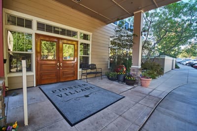 Entrance to Pioneer Village with wooden doors and pathway