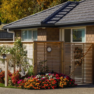 Charming entrance with flowers and wooden fencing