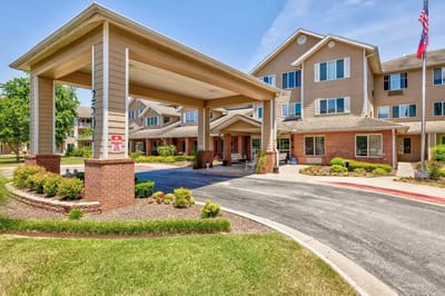 Front entrance of a senior living facility with landscaping