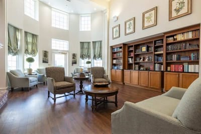 Interior view of a bright common area with seating and bookshelves