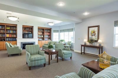 Bright common area with comfortable seating and bookshelves