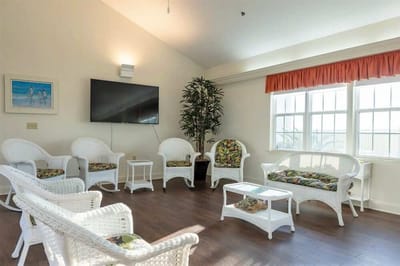 Common area with wicker furniture and a television