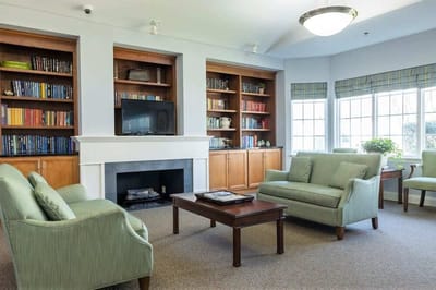 Common area with green seating and bookshelves
