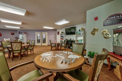 Interior activity room with game tables and chairs