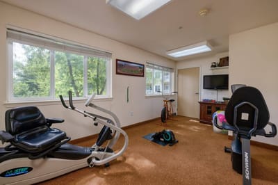 Exercise equipment in a brightly lit activity room