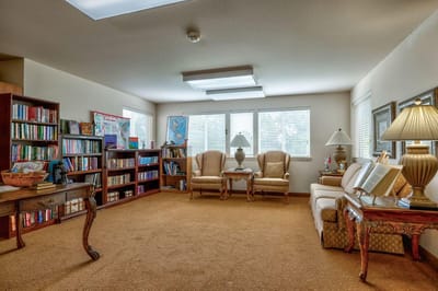 Interior of a cozy common area with bookshelves and seating
