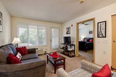 Cozy resident room with living area and bedroom visible