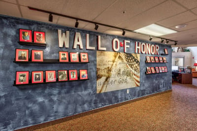 Wall of Honor featuring framed portraits.