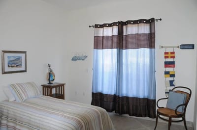 Cozy bedroom with a bed and striped curtains
