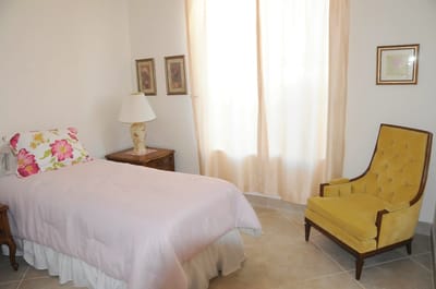 Cozy resident room with a bed and armchair