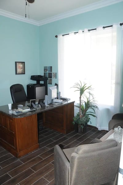 An office space with a desk and chairs