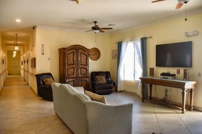 Common area with seating and decor in a nursing home.