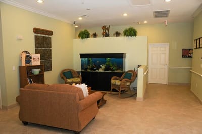 Common area with comfortable seating and an aquarium