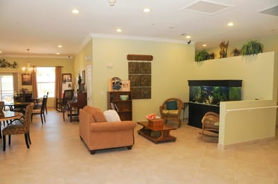 A cozy common area with comfortable seating and an aquarium